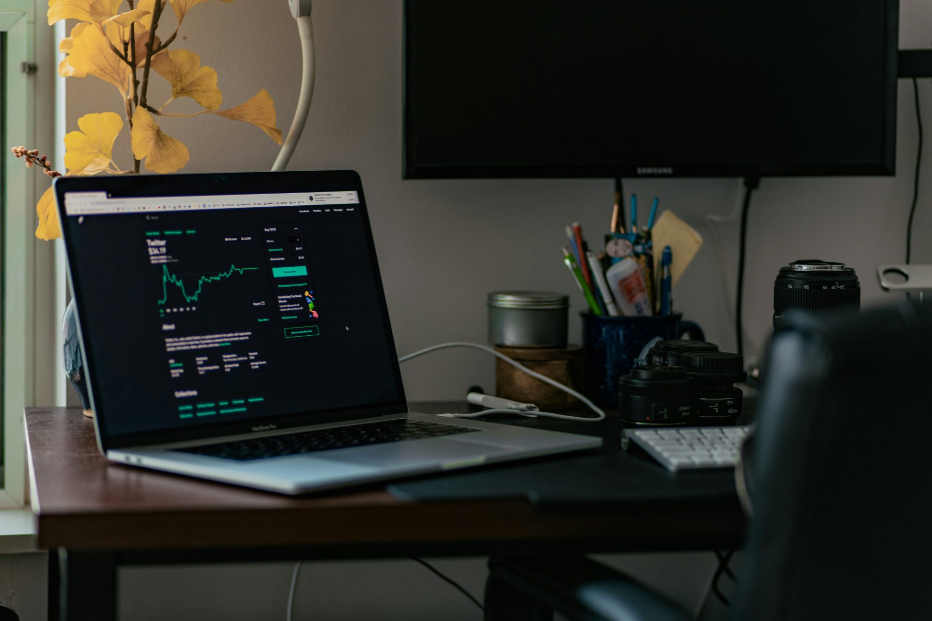 a laptop computer sitting on top of a wooden desk